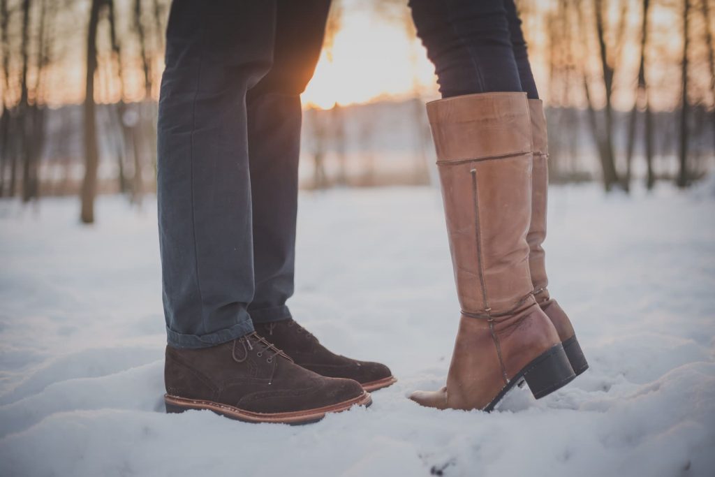 couple's legs on the snow