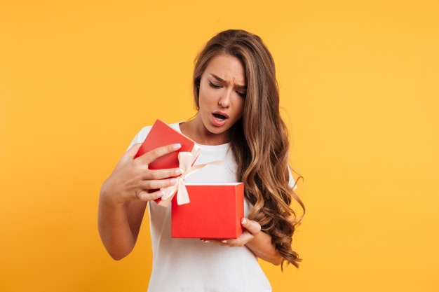 portrait-upset-disappointed-girl-opening-gift-box