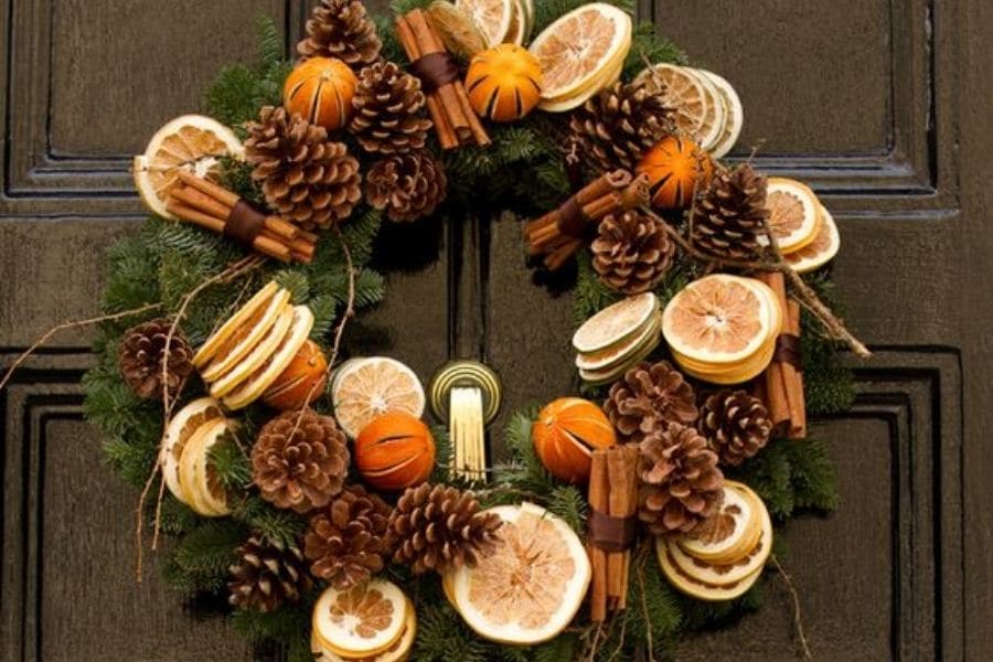 mixed fruit and pine cones wreath hang on a door