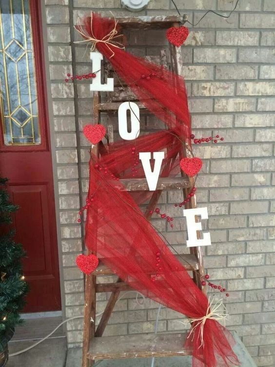 Valentines ladder decorated with red ruffled burlap