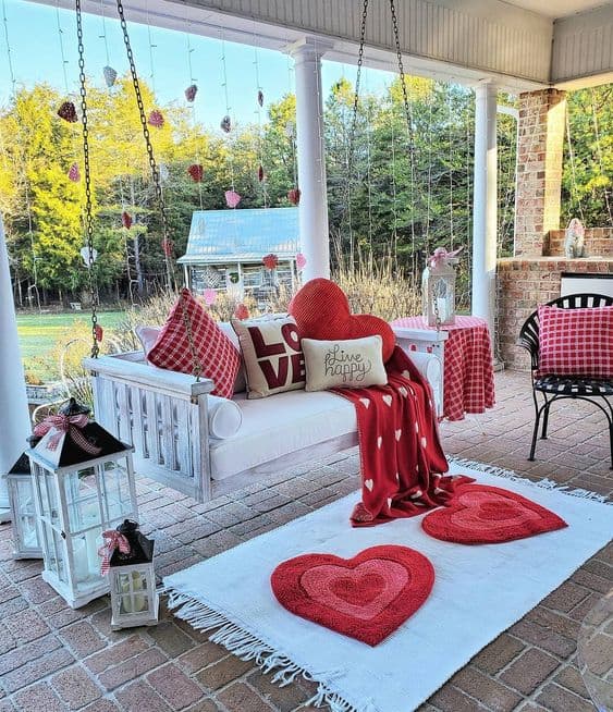 red cushions on a white porch swing