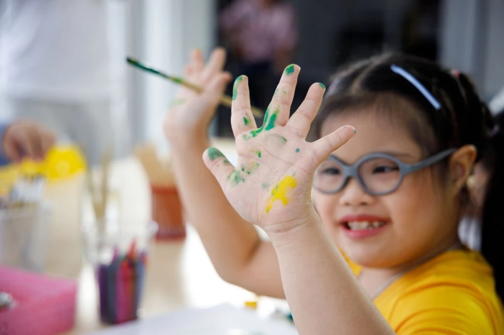 girl with autism painting her hand