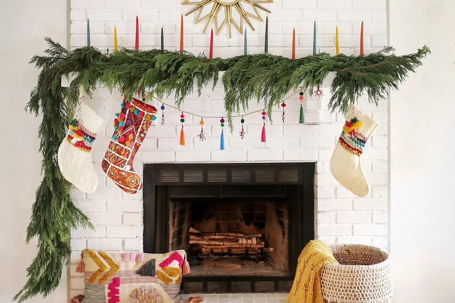 mantel decorated with garlands and colorful socks
